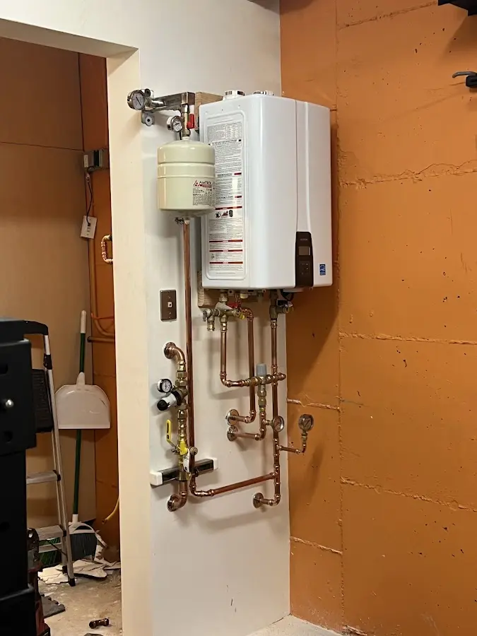 Plumbing technician inspecting water heater connections in Uniontown